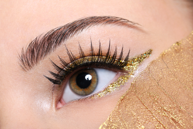 macro shot woman eye with false eyelashes yellow golden make up 1
